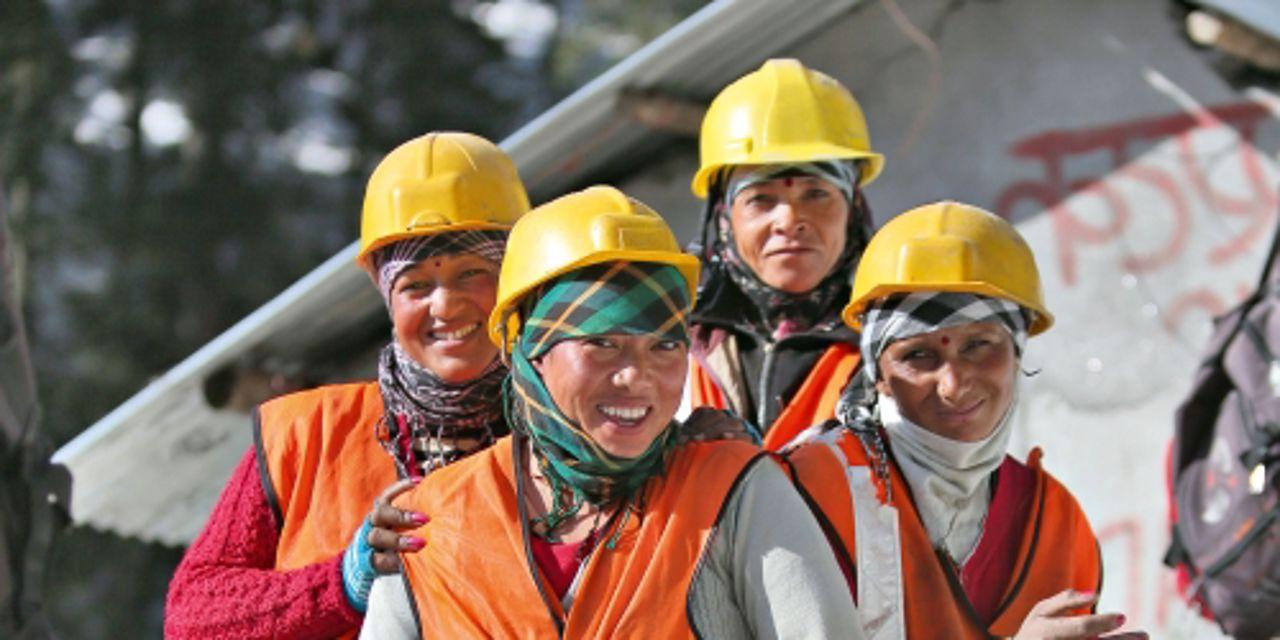 A team of four people in helmets